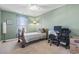 Charming bedroom features a sage green wall, neutral carpet and a sunny window at 817 Old Castle Loop, Myrtle Beach, SC 29579