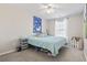 Cozy bedroom with soft blue accents, a comfortable bed, and natural light from a window at 817 Old Castle Loop, Myrtle Beach, SC 29579