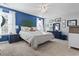 Main bedroom with blue walls, plush bed, and ceiling fan at 817 Old Castle Loop, Myrtle Beach, SC 29579