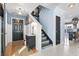 Inviting entryway with staircase, black front door, and stylish decor at 817 Old Castle Loop, Myrtle Beach, SC 29579