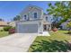 Charming two-story home with a well-manicured lawn, paved walkway and attached garage at 817 Old Castle Loop, Myrtle Beach, SC 29579