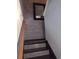 Hallway featuring brick accent wall, decorative mirror, and staircase with patterned stair treads at 817 Old Castle Loop, Myrtle Beach, SC 29579