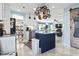 A chef's kitchen with stainless appliances, white cabinetry, and a pot rack above the island at 817 Old Castle Loop, Myrtle Beach, SC 29579