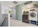 Hallway laundry area with modern appliances and decorative shelving at 817 Old Castle Loop, Myrtle Beach, SC 29579