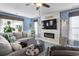 Comfortable living room featuring a modern fireplace, large TV, stylish decor, and a ceiling fan at 817 Old Castle Loop, Myrtle Beach, SC 29579