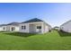 Exterior view of home with backyard and green lawn at 842 Cypress Preserve Circle, Longs, SC 29568