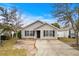 Tan house with black shutters and a driveway at 869 Silvercrest Dr., Myrtle Beach, SC 29579