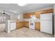 Bright kitchen with wood cabinets, white appliances, and tile floor at 869 Silvercrest Dr., Myrtle Beach, SC 29579