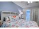 Primary bedroom with a king bed, access to bathroom and closet, and coastal decor at 880 Fairway Dr. # 302Bb, Longs, SC 29568