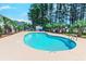 Inviting kidney-shaped swimming pool with surrounding patio at 880 Fairway Dr. # 302Bb, Longs, SC 29568