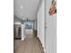Open-concept entryway featuring stylish flooring, modern lighting, and a glimpse of a private balcony in the distance at 901 West Port Dr. # 1706, North Myrtle Beach, SC 29582