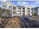 Three-story building with ample parking and inviting landscaping at 901 West Port Dr. # 1706, North Myrtle Beach, SC 29582