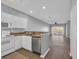 Bright open kitchen with classic white cabinets, modern appliances, and a view into the cozy living space and the outdoors at 901 West Port Dr. # 1706, North Myrtle Beach, SC 29582