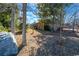 A shady backyard featuring a well-maintained lawn and a bird bath, with a glimpse of the brick house at 1020 Thomas Ave., North Myrtle Beach, SC 29582