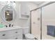 Updated bathroom features a vanity with oval mirror and glass-enclosed shower at 1020 Thomas Ave., North Myrtle Beach, SC 29582