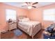 Bedroom with ceiling fan, hardwood floors, and light pink walls at 1020 Thomas Ave., North Myrtle Beach, SC 29582