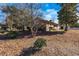 Exterior showing the side of the brick home with some bare trees and brown lawn at 1020 Thomas Ave., North Myrtle Beach, SC 29582