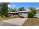 Charming brick home with well-manicured lawn, white trim, and a convenient attached garage with a red golf cart at 1020 Thomas Ave., North Myrtle Beach, SC 29582