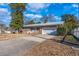 Brick house with a metal roof, attached garage, and landscaping at 1020 Thomas Ave., North Myrtle Beach, SC 29582