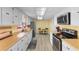 Bright kitchen features modern appliances, wood countertops, white cabinetry, and a small dining set at 1020 Thomas Ave., North Myrtle Beach, SC 29582