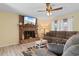 Cozy living room showcasing a brick fireplace, plush seating, and abundant natural light through bright windows at 1020 Thomas Ave., North Myrtle Beach, SC 29582