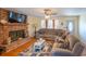 Living room with sectional sofa, brick fireplace, and hardwood floors at 1020 Thomas Ave., North Myrtle Beach, SC 29582