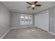 Spacious bedroom with ceiling fan, large windows, and ample closet space at 103 Lakeside Dr., Tabor City, NC 28463