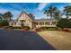 Inviting two-story home featuring a charming facade and lush landscaping at 103 Lakeside Dr., Tabor City, NC 28463