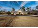 Beautiful two-story home with a wrap-around porch and manicured lawn at 103 Lakeside Dr., Tabor City, NC 28463