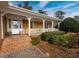 Spacious front porch with brick steps and white columns at 103 Lakeside Dr., Tabor City, NC 28463