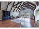 Great room with high ceilings, exposed beams, hardwood floors, and a wall of windows at 103 Lakeside Dr., Tabor City, NC 28463