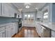 Modern kitchen with white cabinets, stainless steel appliances, and a farmhouse sink at 103 Lakeside Dr., Tabor City, NC 28463