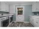 Laundry room with washer, dryer, white cabinets, and tiled floor at 103 Lakeside Dr., Tabor City, NC 28463