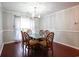 Bright dining room featuring a glass-top table and six chairs at 1047 Rose Haven Dr., Conway, SC 29527