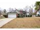 Brick ranch home with attached garage and landscaped lawn at 1047 Rose Haven Dr., Conway, SC 29527