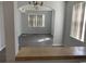 Dining room with gray vinyl plank flooring and a pass-through to the living room at 105 S Merriman Rd., Georgetown, SC 29440