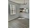 Dining room with gray vinyl plank flooring and a view into the kitchen at 105 S Merriman Rd., Georgetown, SC 29440