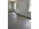 Spacious living room with gray vinyl plank flooring and windows at 105 S Merriman Rd., Georgetown, SC 29440