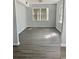 Bright living room featuring gray vinyl plank flooring and large windows at 105 S Merriman Rd., Georgetown, SC 29440