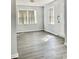 Bright living room with gray vinyl plank flooring and neutral walls at 105 S Merriman Rd., Georgetown, SC 29440