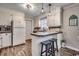 Galley kitchen with white cabinets, tile backsplash, and a breakfast bar at 1100 Naomi Ave., Conway, SC 29526