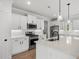 Modern kitchen with stainless appliances, white cabinets and light countertops at 1201 Possum Trot Rd., North Myrtle Beach, SC 29582