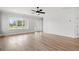 Light filled living room with wood look floors, neutral paint and large windows at 1201 Possum Trot Rd., North Myrtle Beach, SC 29582