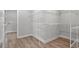 Empty walk-in closet with white wire shelving and wood-look floors at 1201 Possum Trot Rd., North Myrtle Beach, SC 29582