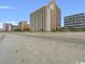 Beachfront condo building with sandy beach and ocean in background at 1205 S Ocean Blvd. # 50412, Myrtle Beach, SC 29577