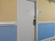 White condo entry door with keyless entry and blue and yellow walls at 1205 S Ocean Blvd. # 50412, Myrtle Beach, SC 29577