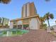 Oceanfront condo building with a green pool and brick patio area at 1205 S Ocean Blvd. # 50412, Myrtle Beach, SC 29577