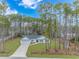 Aerial view of a house with a large yard and driveway at 121 Crossroad Dr. Nw, Calabash, SC 28467