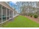 Home's backyard features a large grassy area and mature trees at 121 Crossroad Dr. Nw, Calabash, SC 28467