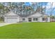 White house with gray shutters, two-car garage, and a well-maintained lawn at 121 Crossroad Dr. Nw, Calabash, SC 28467